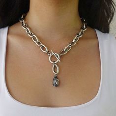 "A beautifulsilver y necklace with a crystal pendant and a  toggle clasp. Crystal color is dark gray \"moon light\". This teardrop necklace has unique eye shaped links.  Easy to match, this teardrop necklace will upgrade any outfit! For reference: model is waering 19'' long necklace Please note: length doesn't include the drop Available in gold plating as well. Materials: Silver plated brass chain and elements - oxidized finish 24 k gold plated brass chain and elements - matte/shiny finish  Meas Silver Lariat Necklace With Chunky Chain, Silver Metal Lariat Necklace With Lobster Clasp, Silver Lariat Drop Necklace, Silver Elegant Toggle Necklace For Jewelry Making, Elegant Silver Lariat Toggle Necklace, Silver Teardrop Clavicle Chain Necklace, Silver Teardrop Pendant Chain Necklace, Silver Drop Chain Necklace With Adjustable Chain, Silver Drop Necklace With Chain Detail