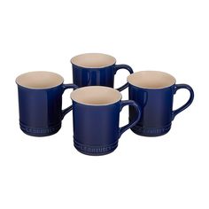 four blue and white coffee mugs sitting next to each other