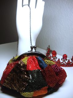 "Vintage SANTI EVENING BAG - Mini-Multicolor Sequins, Beads & Silk Evening Bag, Clutch, Shoulder Bag or Should/Cross-Body Bag. Dar Gray Metallic Frame and Chain Strap. Some minor signs of wear, including some separation of the orange silk threading. Clean red lining. Measures 6\" long, 5\" to top of kiss-lock and 3.5\" deep with a 25\" strap drop. Original \"Santi\" label. Will not hold a cell phone." Vintage Multicolor Beaded Evening Bag, Multicolor Handmade Evening Bag For Everyday Use, Handmade Multicolor Handheld Evening Bag, Multicolor Beaded Bag For Evening, Embellished Multicolor Evening Bag, Embellished Multicolor Bags As Fashion Accessory, Multicolor Beaded Pouch Bag, Multicolor Beaded Handheld Shoulder Bag, Multicolor Beaded Evening Bag