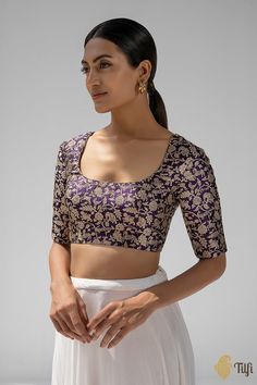 "Handcrafted\u00a0luxury! In a regal shade and a beautiful\u00a0shikargah jaal pattern in\u00a0old gold zari, this blouse is certain to become your new favourite.\u00a0A versatile\u00a0silhouette\u00a0and a delicate dori tie-up at the back.\n\u00a0\n\n\n Color - A beautiful\u00a0shade of Deep Purple\n\n Fabric - Pure Katan Silk\nNote - The blouse is made in standardized sizes as specified below\nPlease allow 10-12 business days for despatch.\u00a0\n\n" Front Blouse Designs, Lengha Blouse Designs, Brocade Blouse Designs, Saree Wearing Styles, Latest Blouse Designs Pattern, Best Blouse Designs, Latest Model Blouse Designs, New Saree Blouse Designs, Saree Blouse Neck Designs