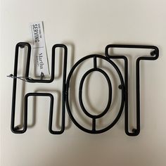 there is a metal object that has the word hot on it with a tag attached to it