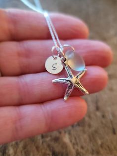 Personalized Sterling Starfish Beach lovers Necklace with Genuine Sea glass Sterling Silver Starfish Charm measures 3/4 inch Sterling Silver round 8mm initial charm can be stamped in lower case or upper case. Genuine Sea Glass measures 3/8 inch to 1/2 inch in size Shown in Sea foam- shades and shapes vary slightly (natural item) Sterling Silver Cable or Box chain: you choose style & length Comes beautifully packaged - ready to give as a gift or keep for yourself! In notes to seller please in Starfish Charm Necklace Perfect For Gifts, Starfish Charm Necklace As Gift, Starfish Charm Necklaces For Gifts, Starfish Charm Necklaces As Gift, Ocean-inspired Starfish Charm Necklace For Gift, Ocean-inspired Starfish Charm Necklace Gift, Moon Phases Necklace, Lovers Necklace, Starfish Necklace