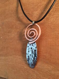 "This pendant is made from pewter with a hand hammered texture and is accented with a hand forged copper swirl. The piece is strung on an 18\" leather cord with lobster clasp closure and measures approximately 2\" in length by 7/8\" wide." Silver Hammered Copper Necklace, Silver Spiral Copper Jewelry, Adjustable Copper Hammered Necklace, Adjustable Hammered Copper Necklace, Star Of Bethlehem, Earring Tree, Shining Star, Cool Diy Projects, Hand Forged