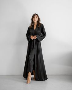 An elegant robe made of Armani silk fabric is presented in a maxi length. The model is styled with long wide sleeves and a belt. The robe emphasizes the figure well and goes well with a nightgown. Available in the following sizes: 42-46 and 48-52 Sizes: This PJ is available in sizes S-M, L-XL Body Measurements: Size  S - M:  Bust measurement - 45-48 cm,   Hips - 51 сm (stretches),  Robe length - 140 cm,  Sleeve length - 53 cm Size  L - XL:  Bust measurement - 50-54 cm,   Hips - 57 сm (stretches),  Robe length - 142 cm,  Sleeve length - 53 cm Colors: Black, White, Gray Materials:  All PJ sets are made of comfortable Armani silk. It's a breathable and allergy-friendly material. Great in terms of thermoregulation.  Fabric content:  Armani silk (50% silk, 45% viscose, 5% elastane) Breathable W Elegant Floor-length Fall Abaya, Elegant Evening Robe In Maxi Length, Elegant Evening Robe Maxi Length, Elegant Maxi Robe For Evening, Elegant Belted Abaya, Elegant Belted Robe With Kimono Sleeves, Elegant Maxi Length Robe For Loungewear, Elegant Belted Kimono, Elegant Silk Maxi Abaya