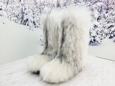 Exclusive white-brown color super fluffy goat fur boots! They are perfect combination of gorgeous look and warmth.  They are lined by a genuine sheepskin and the outside part is made of a really soft goat fur.  26 cm tall Boots are designed for women who love the uniqueness and warmth, as withstand up to 50 degrees Celsius below zero. COLORS: We have lot of fur, so YOU CAN CHOOSE A FUR FOR MAKING YOUR OWN EXCLUSIVE PAIR! --------------------------------------------------------------------------- White Fluffy Boots, White Sheepskin Boots For Winter, White Boots With Faux Fur Lining, Glamorous Silver Winter Boots, Winter White Sheepskin Boots, White Sheepskin Winter Boots, White Faux Fur Boots With Round Toe, White Faux Fur Trimmed Boots, Fur Boots White