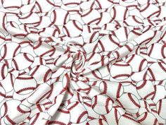 a red and white fabric with baseballs printed on the side, as if it were an ornament