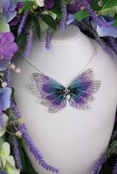 A must have for all fairies! A truly beautiful soft blue and purple necklace, made out of enchanting fairy wings. The necklace is embellished with beads, silver gems and a dash of silver glitter. The pendant measures approximately 11cm across. This delicate array of fairy wings is really rather lovely. It is perfect for all fairy lovers - whether to be worn as part of a costume, or simply as a necklace for everyday wear. It is super light weight, and flexible to touch (please don't bend, however!) Please note that the wings may grow cloudy/opaque over time when exposed to sunlight, heat, perspiration and makeup. The wings should also avoid contact with water.  The chain measures approximately 17 inches in length. However, the chain can be made longer or shorter if you wish - please leave a Handmade Purple Fantasy Necklaces, Handmade Purple Fairycore Jewelry, Handmade Purple Fantasy Necklace, Purple Fairycore Jewelry For Gifts, Fairycore Purple Jewelry As A Gift, Purple Whimsical Necklace For Party, Purple Fairycore Jewelry For Jewelry Making, Whimsical Purple Necklace For Party, Purple Fairycore Jewelry For Party