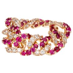 Vintage retro 1940's flexible link 18k rose gold ring with 24 round rubies and 24 round diamonds. Handmade and not sizable. 24 round fine red rubies, VS-SI approx. .72cts 24 round brilliant cut diamonds, H VS approx. .60cts Size 6.5 and not sizable 18k rose gold Stamped: 750 7.9 grams Width at top: 8.7mm Height at top: 2.0mm Width at bottom: 8.7mm