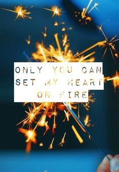 someone holding a sparkler that says only you can set my heart on fire