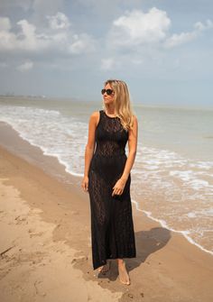 This stunning crochet maxi dress features a drawstring to tie at the neck, an open back, and an intricate crochet pattern. The dress is transparent and slightly tight, with the versatility for casual days at the beach or breezy nights. Sizes: S-M / M-L S-M: Length 45.67 in - Width 11.02 in M-L: Length 47.24 in - Width 11.81 in 100% cotton Washing: handwash Lace Maxi Dress For Beach Cover-up, Black Maxi Dress For Beach Party, Lace Maxi Dress For Vacation, Black Crochet Dress For Beach, Lace Maxi Dress For Beach, Fitted Long Beach Dress, Bohemian Lace Maxi Dress For Beach Season, Lace Maxi Dress For The Beach, Black Crochet Beachwear Dress For Beach