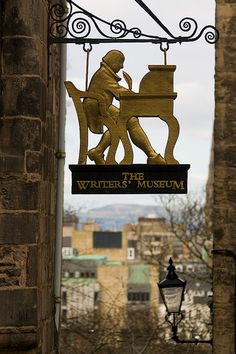 a sign hanging from the side of a building that says the writer's museum