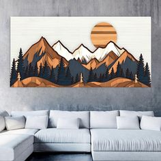 a living room with a couch and large painting on the wall above it that shows mountains