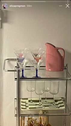 there is a shelf with wine glasses on it