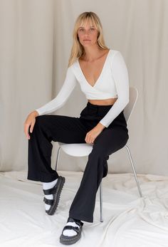 The Wrap Me Up Crop Top features a stretch fabrication with wrap tie body and long sleeves. The perfect basic to pair with our Giselle Trouser. Color: White Wrap Body Long Sleeve 65% Cotton/32% Poly/3% Spandex Model Wearing Size Small and is 32B Bust Versatile Stretch Wrap Top With Long Sleeves, Elegant Stretch Wrap Top With Long Sleeves, Stretch Wrap Top For Work, Fitted Wrap Top For Work, Versatile Fitted Wrap Top For Workwear, Chic Fitted Solid Wrap Top, Elegant Fitted Solid Color Wrap Top, Fitted Wrap Top For Night Out, Chic Stretch Long Sleeve Wrap Top