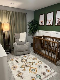 a baby's room with a chair, crib and pictures on the wall