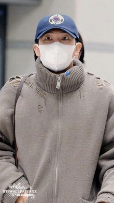 a person wearing a face mask and jacket