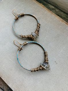 "Large 2\" brass hoops have been hammered and oxidized with a grunge dark turquoise patina and hand wrapped with dark herkimer diamonds & brass wire. Each hoop dangles 2.5\" from 14k goldfill earwires. Handmade in NY" Electroformed Brass Hoop Earrings, Adjustable Soldered Hoop Earrings For Gifts, Rustic Handmade Hoop Earrings, Adjustable Rustic Metal Earrings, Earwires Handmade, Boho Crystal, Syracuse Ny, Brass Hoops, Diamond Bangles Bracelet