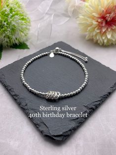 "*ITEM DESCRIPTION* This lovely beaded bracelet is made using 3mm sterling silver beads, with 4 fine silver circle charms with each circle representing each decade. Each bracelet has a sterling silver 925 tag attached.  This bracelet is also available with 3, 5 or 6 circle charms. Please see separate listings below.  30th birthday bracelet  https://etsy.me/2pyRTOe  50th birthday bracelet  https://etsy.me/2HmKY4Q 60th birthday bracelet  https://etsy.me/2t7MoYr  There is a choice of silver or gold Silver Sterling Beaded Bracelets For Birthday, Adjustable Sterling Silver Bracelet For Birthday, Anniversary Silver Beaded Bracelets, Silver Bracelets With Round Beads For Birthday, Elegant Silver Beaded Bracelets For Birthday Gift, Silver Hypoallergenic Beaded Bracelets For Birthday, Silver Beaded Bracelets For Mother's Day And Birthday Gifts, Dainty Sterling Silver Beaded Bracelets For Anniversary, Sterling Silver Beaded Bracelets For Anniversary