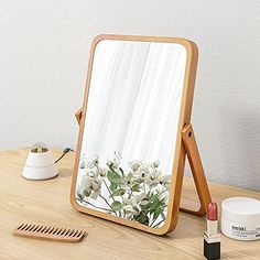 a mirror sitting on top of a wooden table