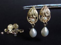 If you want to pay with PayPal, please contact me. Earring details: * The earrings made from 14 karats solid yellow gold. * Earrings length 1.18inch/ 3cm. * 2 White freshwater pearl dangle at the bottom. * 2 small pearls. Delicate gold handmade Filigree pear shape pearl earrings. A perfect pearl bride earrings to wear as your wedding jewelry and also enjoy after the big day. The hanging pearl gives an elegant look. Can be ordered with different size of a pearl. Material available: 14/18K yellow/ Elegant 14k Gold Clip-on Earrings For Wedding, Elegant 14k Gold Clip-on Wedding Earrings, 14k Gold Filigree Earrings For Wedding, Elegant Yellow Gold Filigree Bridal Earrings, Yellow Gold Pearl Earrings With Intricate Design For Gift, Elegant Filigree Drop Pearl Earrings, Traditional Pierced Pearl Earrings For Formal Occasions, 14k Gold Pierced Pearl Earrings For Wedding, Ornate Filigree Pearl Earrings For Formal Occasions