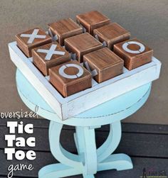 a wooden tic tac toe game sitting on top of a table