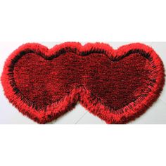 two red hearts shaped rugs sitting on top of each other