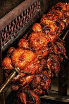 chicken is being cooked on the grill with tongs