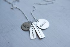 "Gorgeous sterling silver 4 charm necklace personalized however you would like them! Perfect for wearing every day and layering with other pieces. All components are solid sterling silver - chain, clasp, jump rings, and bars/discs. Large disc measures 3/4\" (19 mm), 9/16\" disc (15 mm), and two rectangles about 1\"x 5/16\" (25 mm X 8 mm). Pick your favorite chain on this one! Please let me know these details in the note to seller box when placing your order - *Name or words/numbers you would lik Everyday Hand Stamped Sterling Silver Necklaces, Silver Sterling Silver Charm Necklaces For Layering, Sterling Silver Charm Name Necklace For Birthday, Customizable Silver Name Necklace For Everyday, Customizable Silver Name Necklace For Everyday Wear, Sterling Silver Engraved Name Necklace, Sterling Silver Hand Stamped Pendant Charm Necklace, Minimalist Sterling Silver Name Necklace With Charms, Everyday Engraved Sterling Silver Name Necklace