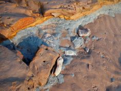 some rocks and sand on the beach