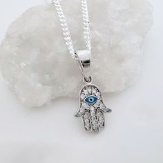 "925 Sterling silver Evil Eye necklace. This Evil Eye necklace is not a tawdry accessory; all you can see in this necklace is made out of Sterling Silver and CZ crystal; CZ comes closer than any other gem material to matching the characteristics of a diamond.  LIKE THIS ITEM?  There's the Facebook and Pinterest , button to Save it to your favorites and revisit it later! ! Or you can  E-mail it! . Take a look at other evil designs: http://etsy.me/XhfBGw  Add your personal touch to this necklace! . Need initials, symbolic charms, etc,? Please visit my adds on section: http://etsy.me/UFmfXa DESCRIPTION: . 925 Sterling Silver Evil Eye 10mmD. . Sterling Silver hearts 7mm with your choice initial or disc 8mm upon request. . Swarovski birthstone of your choice month. ~ 925 Sterling Silver Italian Sterling Silver Star Of David Charms Jewelry, Sterling Silver Charm Necklace For Good Luck, Sterling Silver Round Pendant Charm Necklace For Good Luck, Sterling Silver Symbolic Pendant Necklace, Spiritual Sterling Silver White Gold Necklaces, Symbolic Sterling Silver Pendant Necklace, Spiritual White Gold Sterling Silver Necklaces, Spiritual Sterling Silver Necklace In White Gold, Spiritual Sterling Silver Nickel-free Charm Necklace