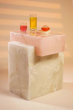 two glasses sitting on top of a marble block