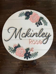 a sign that says mckinley rose with flowers and leaves on the bottom of it