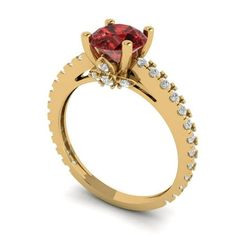 a yellow gold engagement ring with a red stone and white diamonds on the side,