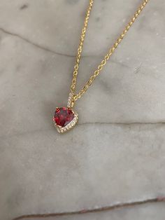 Ruby red heart jewel pendant with a crystal paved bail measuring 1.8 cm x 1 cm. Hung on a gold-plated chain which measures 45.7 cm (18 inches). Comes in a black velvet cushioned box. As seen in last photo. Free of charge. INTERNATIONAL BUYERS please choose the tracking option if you would like your order to be tracked. FREE tracking upgrade with 3 items or more purchased. JEWELLERY CARE please don't wear plated jewellery in the shower, bath or swimming for the plating to last longer. Red Gemstone Heart Cut Necklace, Red Heart Cut Necklace For Formal Occasions, Red Heart Pendant For Formal Occasion, Red Gemstone Heart Pendant Necklace, Red Heart Jewelry For Formal Occasions, Elegant Red Gemstone Heart Necklace, Formal Valentine's Day Gold Plated Heart Necklace, Red Heart Pendant Necklace For Party, Red Heart Cut Necklace For Party