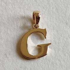 This is an exquisite initial charm pendant set in 14K Solid Gold.  An elegant design, perfect for any occassion. ITEM DETAILS: ✓ Letter : G ✓ Gold Kt: Solid 14K Yellow Gold ✓ 14 K Gold Weight : 1.20 grams ✓ Gross Weight: 1.20 grams >>The Gold purity is guaranteed and it comes with authentic 14K gold hallmark. >>A-Z letters available on my Etsy Shop. CUSTOMER SUPPORT: We are available 24/7 to respond to all your queries! PACKAGING: The pendant comes in layers of safe and secure wrapping along with a free Handmade Jewelry Box. Birthday Gift Letter, Alphabet G, Initial G, Gift Letter, Locket Design, Alphabet Necklace, Handmade Jewelry Box, Golden Rutilated Quartz, Gold G