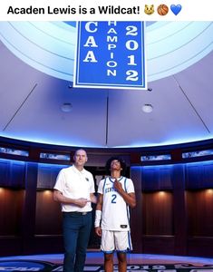 two people standing in front of a basketball court with the words coach lewis is a wildcat