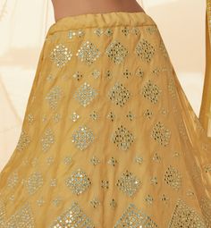 COLOR : Pale Mustard FABRIC : Top (Blouse) - Organza, Bottom (Lehenga) - Organza, Dupatta - Soft Net WORK : Heavy Silk Thread Embroidery, Heavy Foil Mirror Work, Floral Motifs, Lace Border OCCASION : Wedding, Reception, Sangeet, Engagement READY-TO-WEAR : NoSTITCHING : Available as semi-stitched fabric, can be stitched using standard size option (+$30). Note: There might be a slight color variation due to lighting and flash used during photoshoot. The bright shade seen is the best closer view of Blouse Organza, Mustard Fabric, Embroidered Wedding, Organza Dupatta, Thread Embroidery, Lace Border, Mirror Work, Silk Thread, Bridal Lehenga