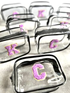 several clear bags with purple letters on them