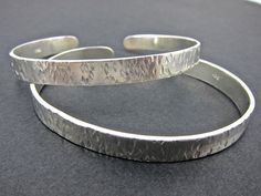 This hammered sterling silver cuff is adjustable to most sizes and can be worn many different ways.  Wear one at a time or a whole stack of them, or combine with a slightly different yet matching cuff as shown in one of the photos. a great addition to your jewelry stash and a quick way to change a look. These cuffs are about 7mm wide. If you would like to have more than two or a different width just let me know and I'll be happy to make it. The price of $65.00 is for one cuff. For more bracelets Keum Boo Earrings, 22k Gold Earrings, Simple Bangle, Mixed Metal Earrings, Peridot Earrings, Jade Earrings, Hammered Sterling Silver, Sterling Silver Cuff Bracelet, Sterling Silver Cuff