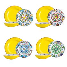 four plates with different designs on them and one has a yellow plate in the middle