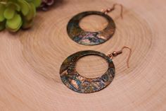 Item Overview *Handmade item *Raw Copper Patina *Ships anywhere in the US from Bellingham, Washington Item Details Unique Copper patina hoop earrings. Made of raw copper that has hand hammered, domed and Patinated by me Patina is a passion of mine because we love the results.  This process of this coloring of patina takes five days.   This pair is a beautiful copper earrings is accented with black, blues, greens, burnt orange and bronze hues.   This coloring is different every time and it's own unique piece Patina is a unique finish and no two pair will be exactly alike but will strongly resemble the picture. Product Overview - Hand hammered, dome shaped and patina - Very light weight and versatile -The copper patina pieces are covered by a thin layer of lacquer in order to save natural co Unique Small Hoop Metal Earrings, Unique Handmade Small Hoop Jewelry, Unique Nickel-free Copper Hoop Earrings, Handmade Metal Round Hoop Earrings, Handmade Small Hoop Metal Earrings, Adjustable Soldered Hoop Earrings For Gifts, Unique Round Hoop Earrings For Jewelry Making, Handmade Copper Round Hoop Earrings, Artisan Metal Hoop Earrings