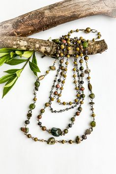 The Ally Unakite Multi Chain Necklace ♡ Product Highlights ♡ Our Ally Unakite Multi Chain Necklace is the perfect accessory to add to any on-trend bohemian style outfit! Layered with any of our many statement necklaces, of your choosing, the Ally Unakite Multi Chain Necklace will be sure to be a wonderful addition to any necklace layering style! ✁ Contents & Measurements ✁ Our Ally Unakite Multi Chain Necklace features: • 4 separate miscellaneous gemstone beaded & brass rosary chain strands. • L Bohemian Green Beaded Chain Jewelry, Earthy Green Necklace For Festivals, Earthy Green Necklace For Festival, Artisan Multi-strand Beaded Chain Jewelry, Bohemian Necklaces For Layering With Unique Variations, Bohemian Long Green Necklace, Bohemian Multi-strand Chain Necklace For Jewelry Making, Bohemian Multi-strand Layering Necklaces, Bohemian Multi-strand Chain Necklace For Layering