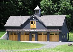 a two car garage with three windows and a steeple