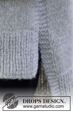 the back side of a white sweater with black buttons