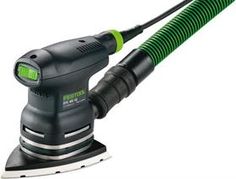 a green and black sander on top of a white surface with a hose attached to it