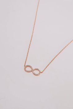 PLX501 (DS1024N) Celebrate eternal love and connection with our Handmade 14K Rose Gold Diamond Infinity Charm Necklace. This exquisite necklace features an infinity symbol charm adorned with natural diamonds, symbolizing everlasting bonds and infinite possibilities. Crafted from 14K rose gold, the necklace exudes a warm and romantic allure. The infinity charm is intricately designed, with each diamond expertly set to create a dazzling display of brilliance. The natural diamonds add a touch of sp Luxury Rose Gold Infinity Jewelry, Elegant Rose Gold Infinity Necklace, Rose Gold Infinity Jewelry With Diamond Accents, Dainty Infinity Rose Gold Necklace, Dainty Rose Gold Infinity Necklace, Rose Gold Infinity Necklace For Anniversary, Dainty Rose Gold Infinity Jewelry, Infinity Necklace With Diamond Accents, Anniversary Rose Gold Necklace With Si Clarity