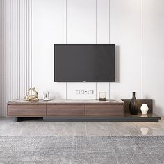 a flat screen tv sitting on top of a wooden entertainment center in a living room