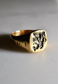 “ The only thing necessary for the triumph of evil is for good men to do nothing” - Edmund Burke Handcrafted and cast ring finished with an etched vintage inspire Griffin mythical creature. Metal: Sterling silver, bronze and 14k gold. Ceremonial Brass Rings With Engraving, Spiritual Brass Engraved Ring, Ceremonial Engraved Brass Rings, Gold Engraved Ring With Antique Finish As Gift, Antique Hand Cast Signet Ring For Gift, Antique Hand-cast Signet Ring For Gift, Antique Bronze Hand Cast Ring, Antique Engraved Brass Signet Ring, Spiritual Gold Brass Signet Ring