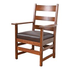 a wooden chair with brown leather seat and armrests on an isolated white background