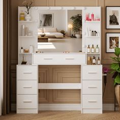 there is a white vanity with drawers and shelves on the wall next to a potted plant